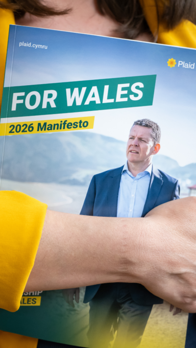 The Plaid Cymru manifesto which says "For Wales" with a picture of Rhun ap Iorwerth being held by a woman in a yellow jacket