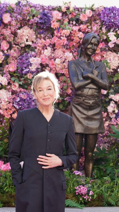 Bridget Jones stands next to a statue of Bridget Jones.