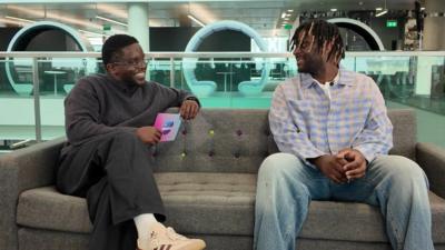 De-Graft talking to Myles Smith on a sofa