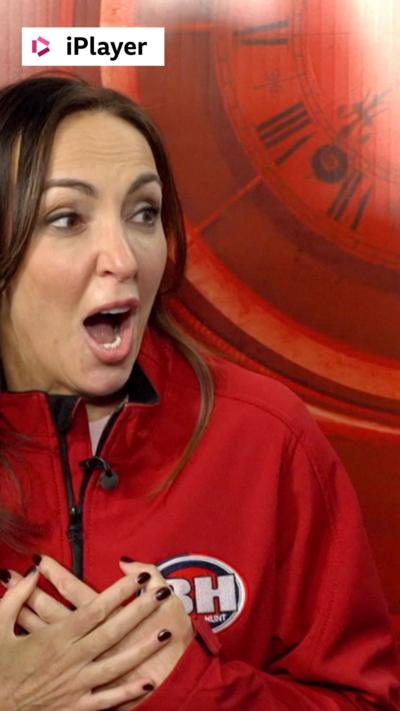 Sally Nugent looks shocked, wearing a red Bargain Hunt jacket 