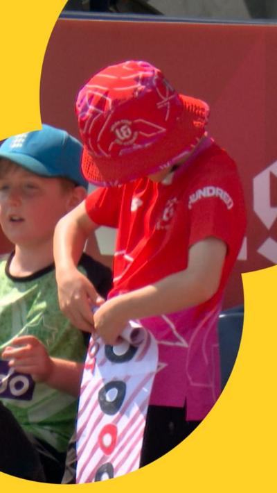 Welsh Fire fan rolling up a Joe Root banner 