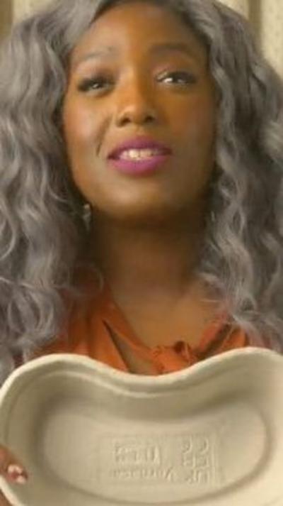 Woman smiling holding a cardboard bowl used in hospitals