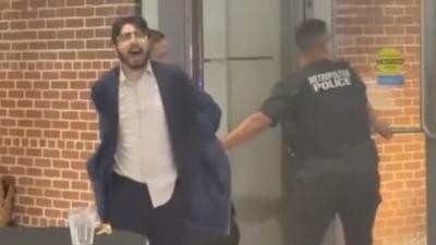 Man being taken away by police