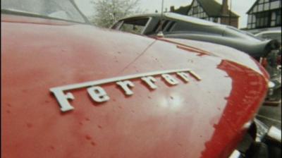 A close up of a Ferrari badge on a red car