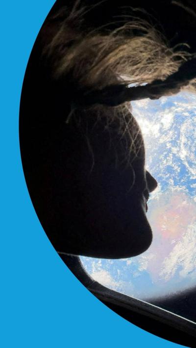 A woman's face is silhouetted in profile in front of a picture of Earth taken from space.
