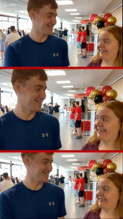 A young woman and a young man smile at one another