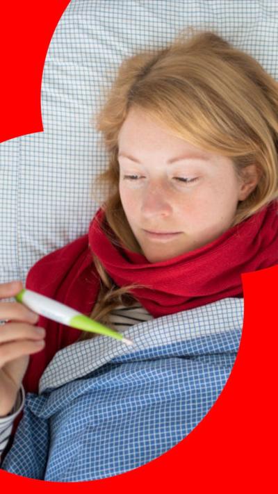Woman laying in bed wearing red scraf and striped jumper
