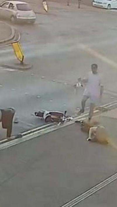 CCTV image of a woman lying in a road after being hit by an e-scooter