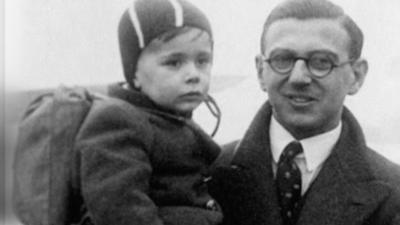 Sir Nicholas Winton carrying a child.