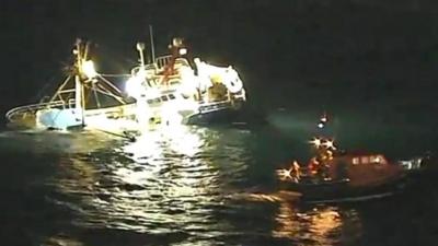 The crew of a Belgian fishing vessel that struck rocks and sank off Cornwall have been reported "safe and well", HM Coastguard has said.