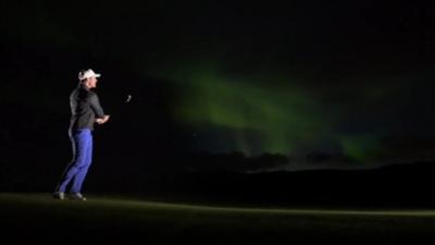 Golfer with Northern Lights