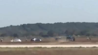 Police cars chasing a white car at Lyon airport