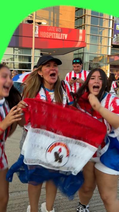Paraguay fans celebrate by holding the Paraguay flag