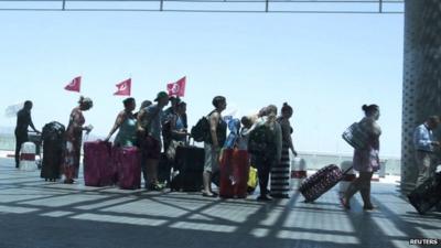 Tourists queue to leave Tunisia at the Enfidha international airport