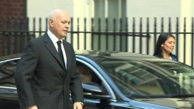 Iain Duncan Smith by a car