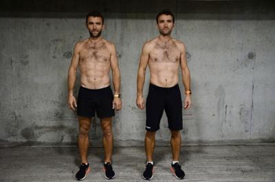 Two identical twins in shorts stand side-by-side