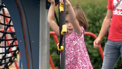 A child plays on a jungle gym