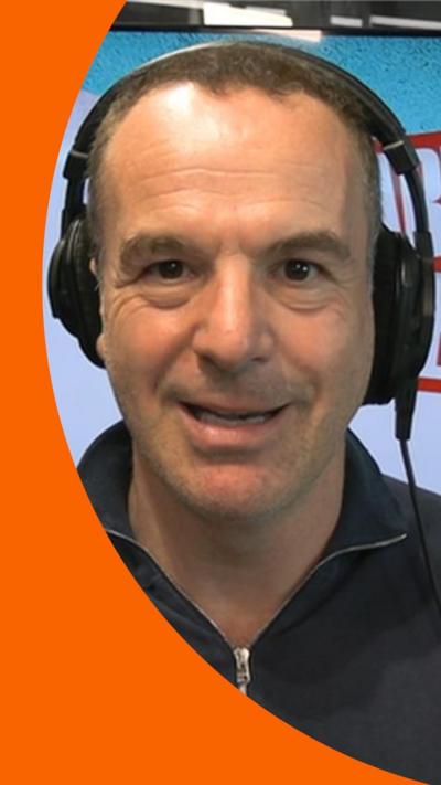 Martin Lewis wearing headphones in a podcast studio