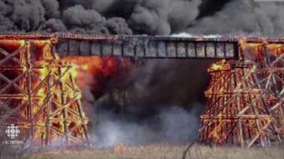 Fire engulfs a rail trestle bridge in Mayerthorpe, Canada