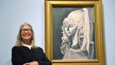 Sylvette David, ex-model of artist Pablo Picasso, with one of his paintings of her