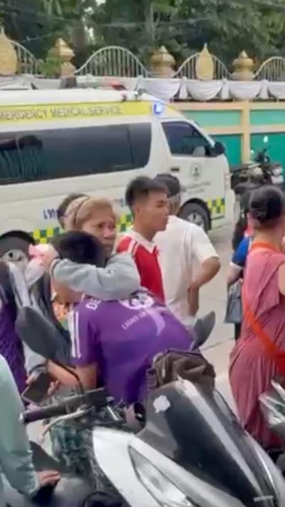 A woman with blonde hair holds a distressed person, wearing a purple uniform.