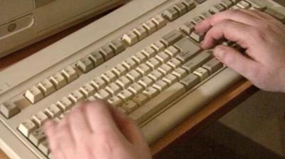 A person typing on a keyboard.