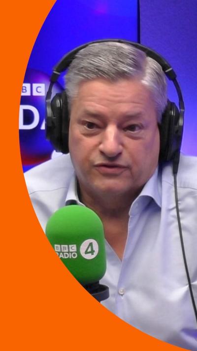 Ted Sarandos wears a white shirt and headphones