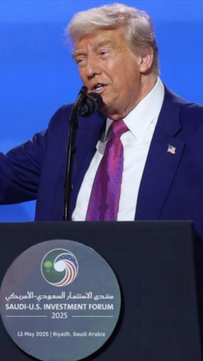 Trump speaking into a microphone