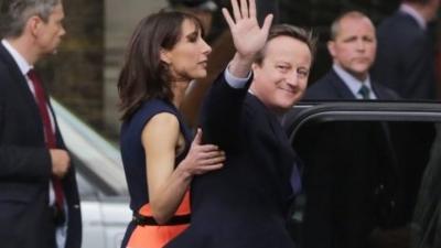 David Cameron waves goodbye as he leaves 10 Downing Street in London, with wife Samantha