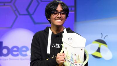 Faizan Zaki holding the 2025 Scripps National Spelling Bee trophy