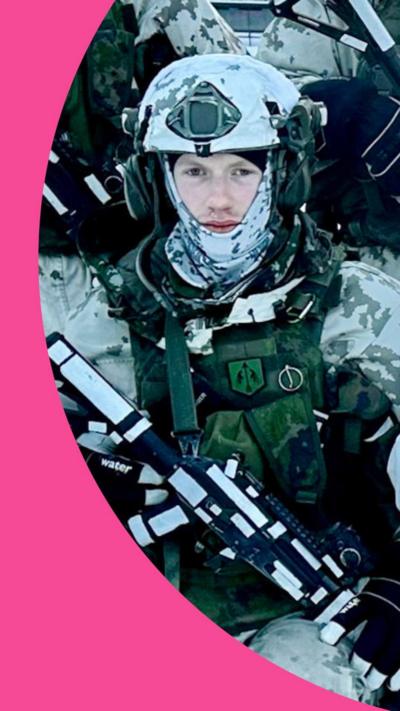 Soldier stands in winter military kit with helmet and body armour in the snow