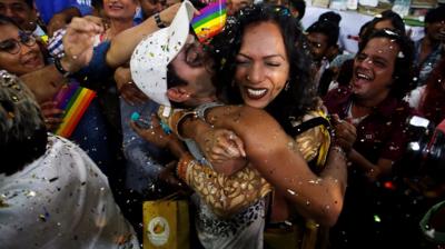 Two people hugging and celebrating with confetti