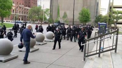 Elderly man approaches police