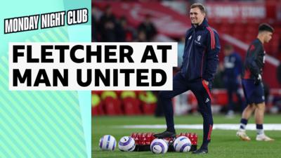 Darren Fletcher smiles with a ball at his feet in navy blue and red Manchester United training kit.
