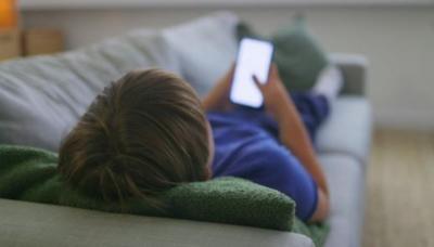 boy looking at his phone.