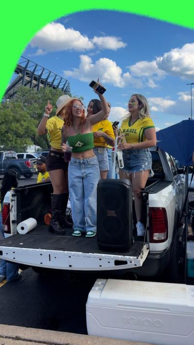 Brazil fans dance on the back of a truck at a tailgate outside Philadelphia's stadium