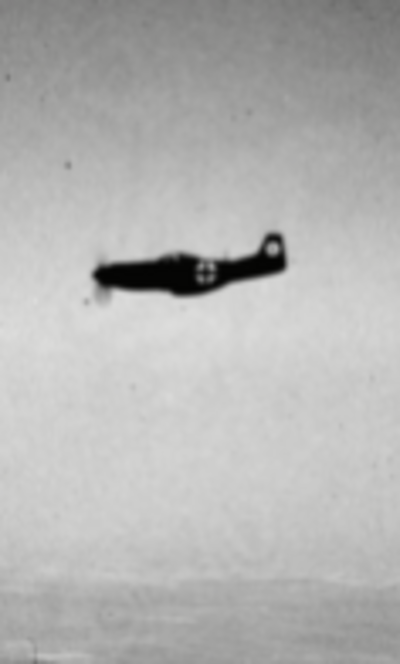A grainy black and grey image of a German Luftwaffe aircraft flying through the air.