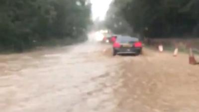 Police in Norfolk close roads as floodwater causes difficult driving conditions.