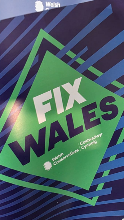 A blue document with a green square saying Fix Wales and the Welsh Conservative logo