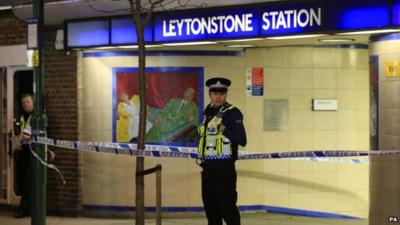 Policeman standing outside Leytonstone Tube station