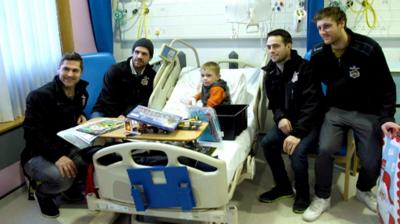 Belfast Giants hospital visit spreads festive cheer as they distribute toys from their annual teddy bear toss