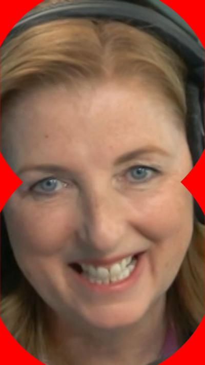 Julie Wilson Nimmo has blonde hair and is wearing headphones.