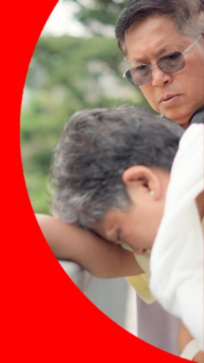 A woman leaning her head on railings with is being helped by a man