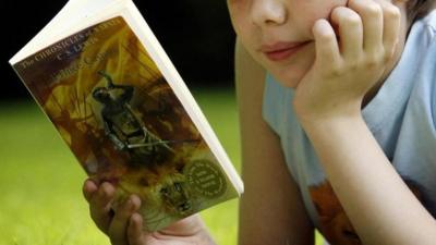 Anonymous child reading a book