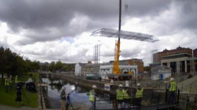 Time-lapse video shows the bridge being lifted into place