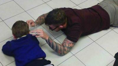 James Williams cutting four-year-old Mason's hair