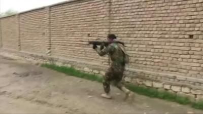 A member of the Afghan security forces fights Taliban militants in Kunduz