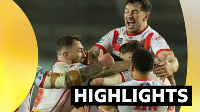 St Helens mob Jonny Lomax after his last-gasp drop goal beats Huddersfield