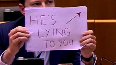 'He's lying to you' sign