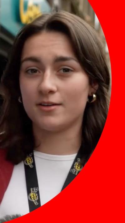 A young woman in white t-shirt and red jacket.